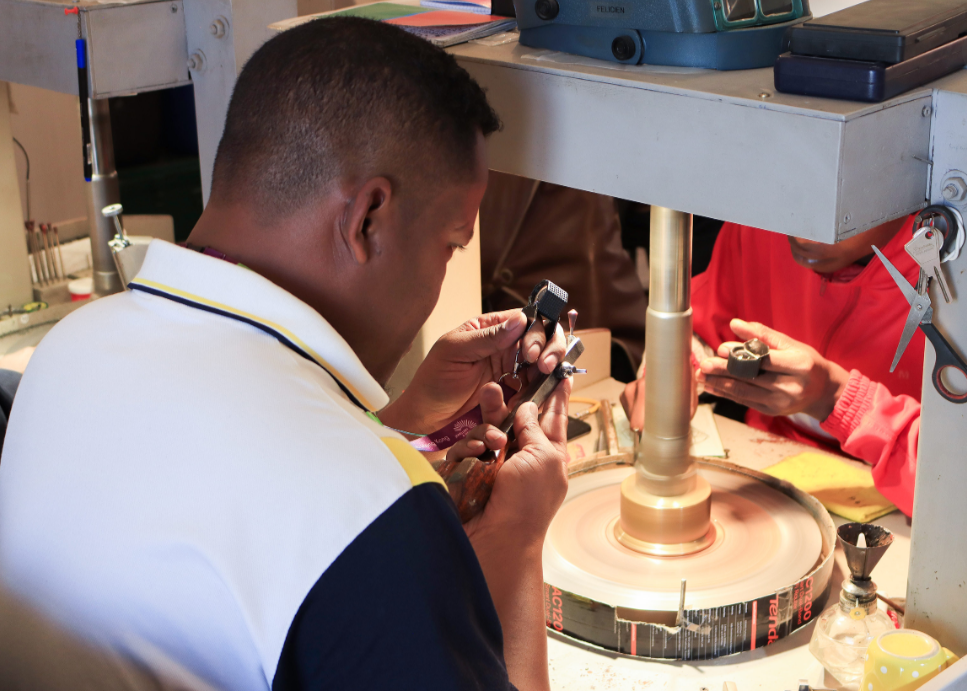Jeweler setting stones under microscope